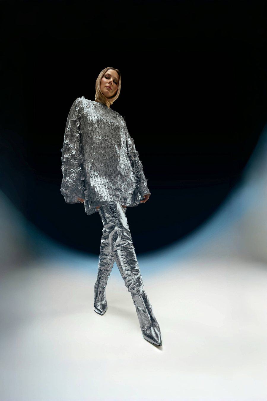 Anna Belyaeva on set — full-length shot of a model in a silver sequin look