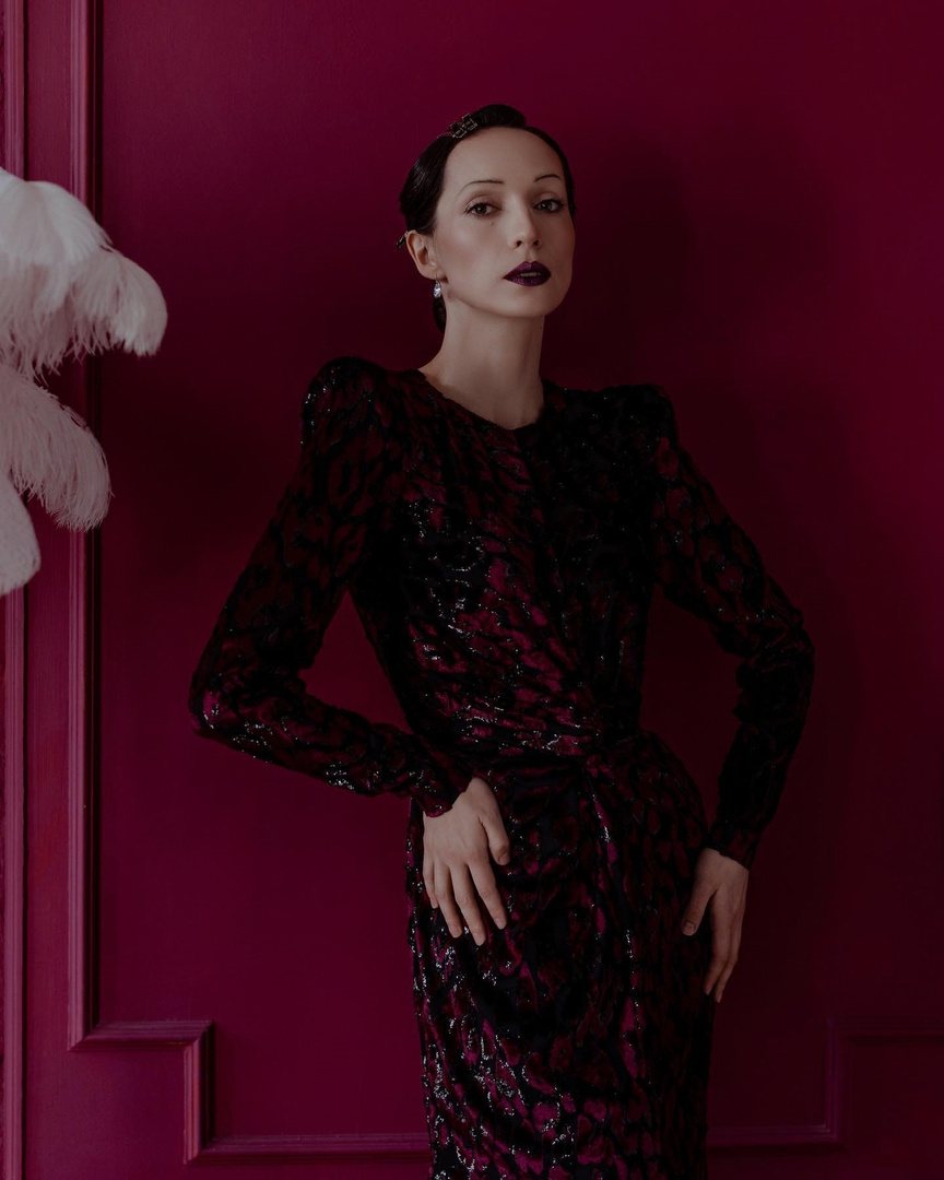Editorial portrait in burgundy: sculpted waves and a dark lip